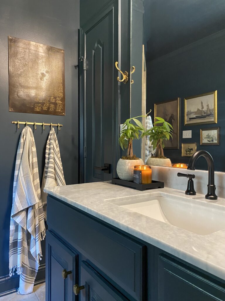 Custom bathroom vanity with black cabinets and marble countertop