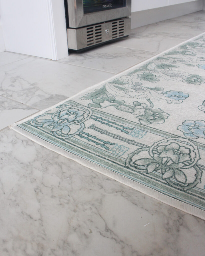 Blue And Green Floral Rug On Marble Tile