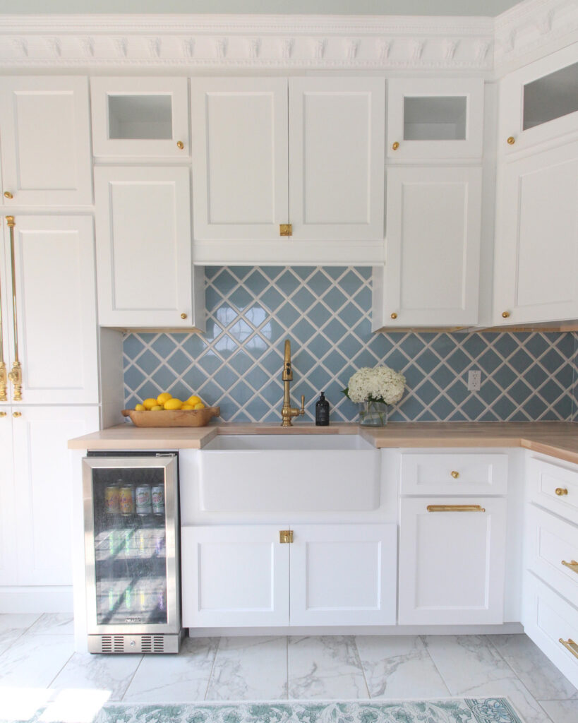 Pool House With White And Light Wood Kitchen And Blue Backsplash