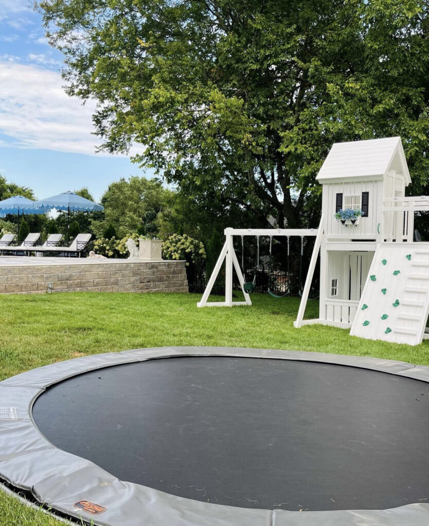 Outdoor trampoline and white playset